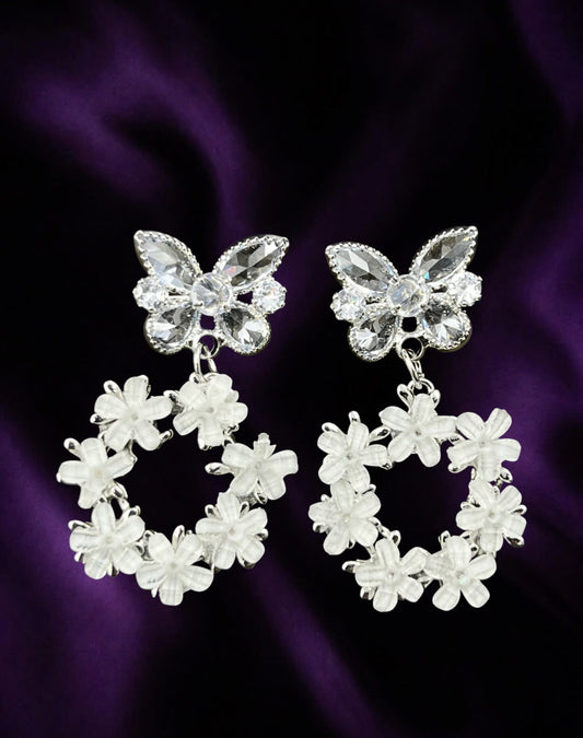 SHE BEAUTY FLORA butterfly earrings featuring crystal butterfly studs and white floral wreath drops on purple silk