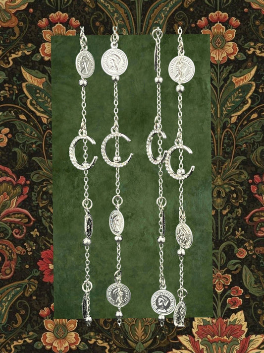 SHE BEAUTY 4-piece silver-toned chain set featuring crescent moon charms, coin pendants, and bell accents.