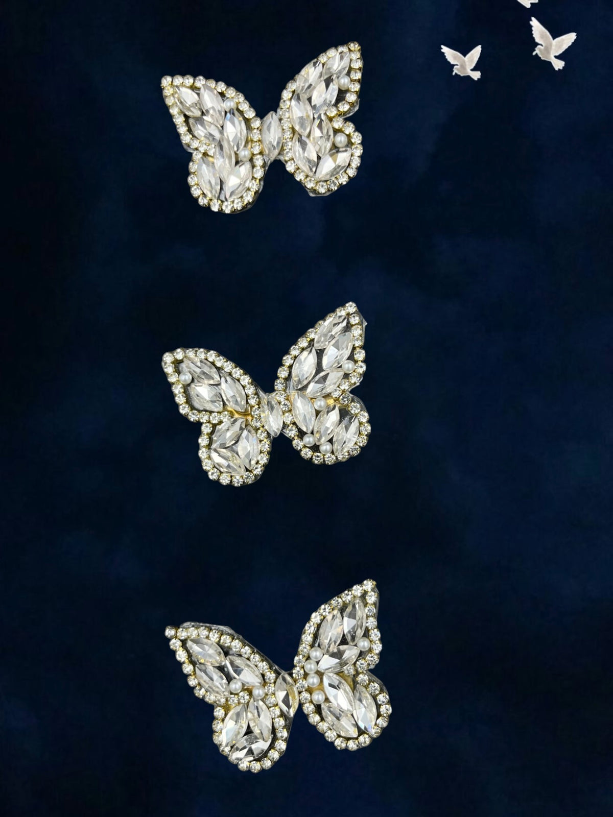SHE BEAUTY crystal butterfly hair pins with clear marquise stones and pearl accents on a dark blue velvet background