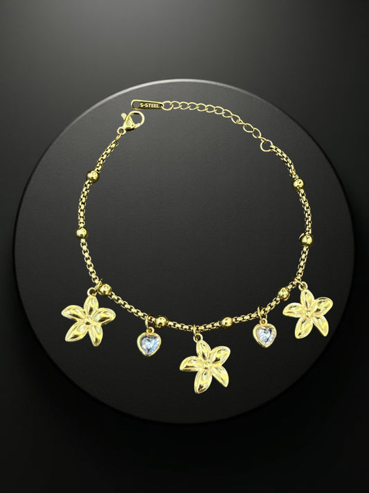 SHE BEAUTY KIYU ZIYU gold-tone chain bracelet featuring flower and heart charms for festive or everyday wear.