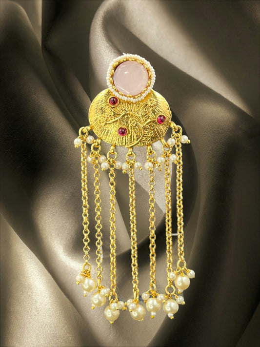 SHE BEAUTY Nakshi gold juda hair brooch with a central pink stone, red accents, and hanging pearl chain tassels.