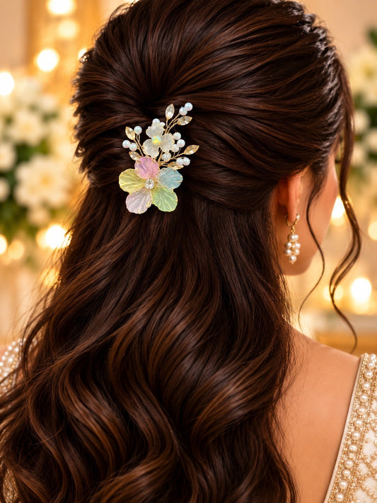 SHE BEAUTY pastel blossom hair pin with pearls and floral accents worn in a woman's wavy brown hair for party wear