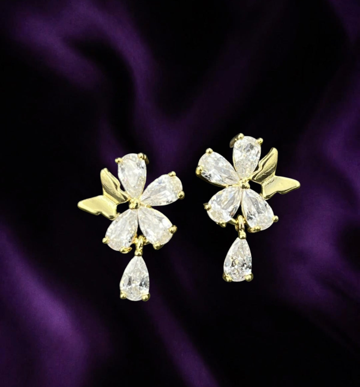 SHE BEAUTY S925 Korean top earrings featuring gold-tone flower petals with sparkling teardrop cubic zirconia stones.