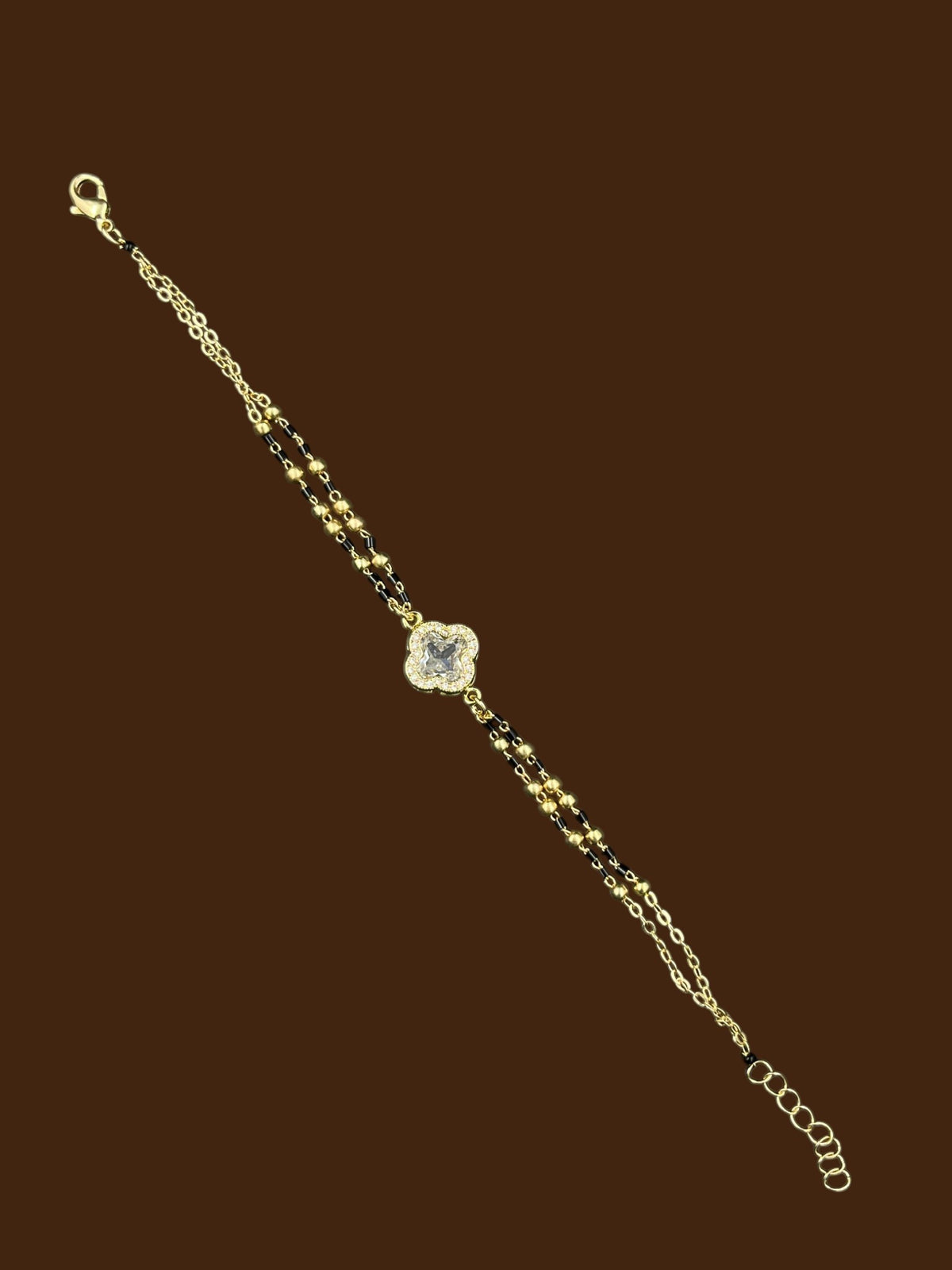 SHE BEAUTY anti-tarnish AD mangalsutra bracelet with a clover-shaped stone charm and gold-tone beaded chain