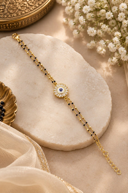 SHE BEAUTY anti-tarnish AD mangalsutra bracelet featuring a central evil eye charm with white stones and black beads.