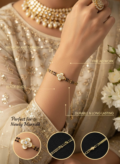 SHE BEAUTY anti-tarnish AD mangalsutra bracelet with black beads and a floral stone charm on a woman's wrist