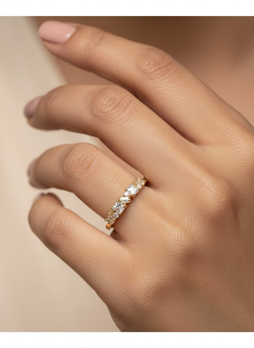 SHE BEAUTY anti-tarnish gold-tone ring featuring sparkling baguette and princess-cut AD stones on a woman's finger