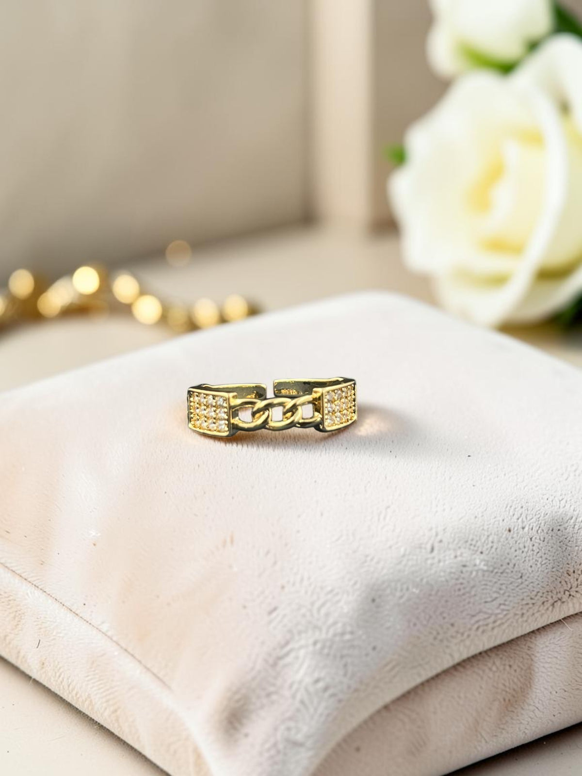 SHE BEAUTY anti-tarnish gold-tone ring with sparkling AD stones and a central chain link design on a velvet cushion.