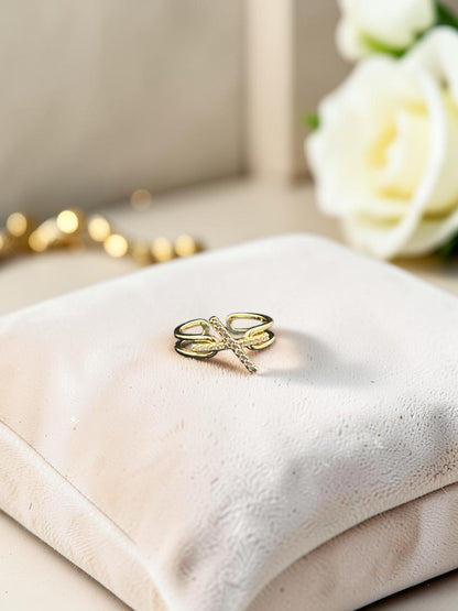 SHE BEAUTY anti-tarnish gold-tone ring with a delicate cross design and sparkling AD stones on a velvet cushion
