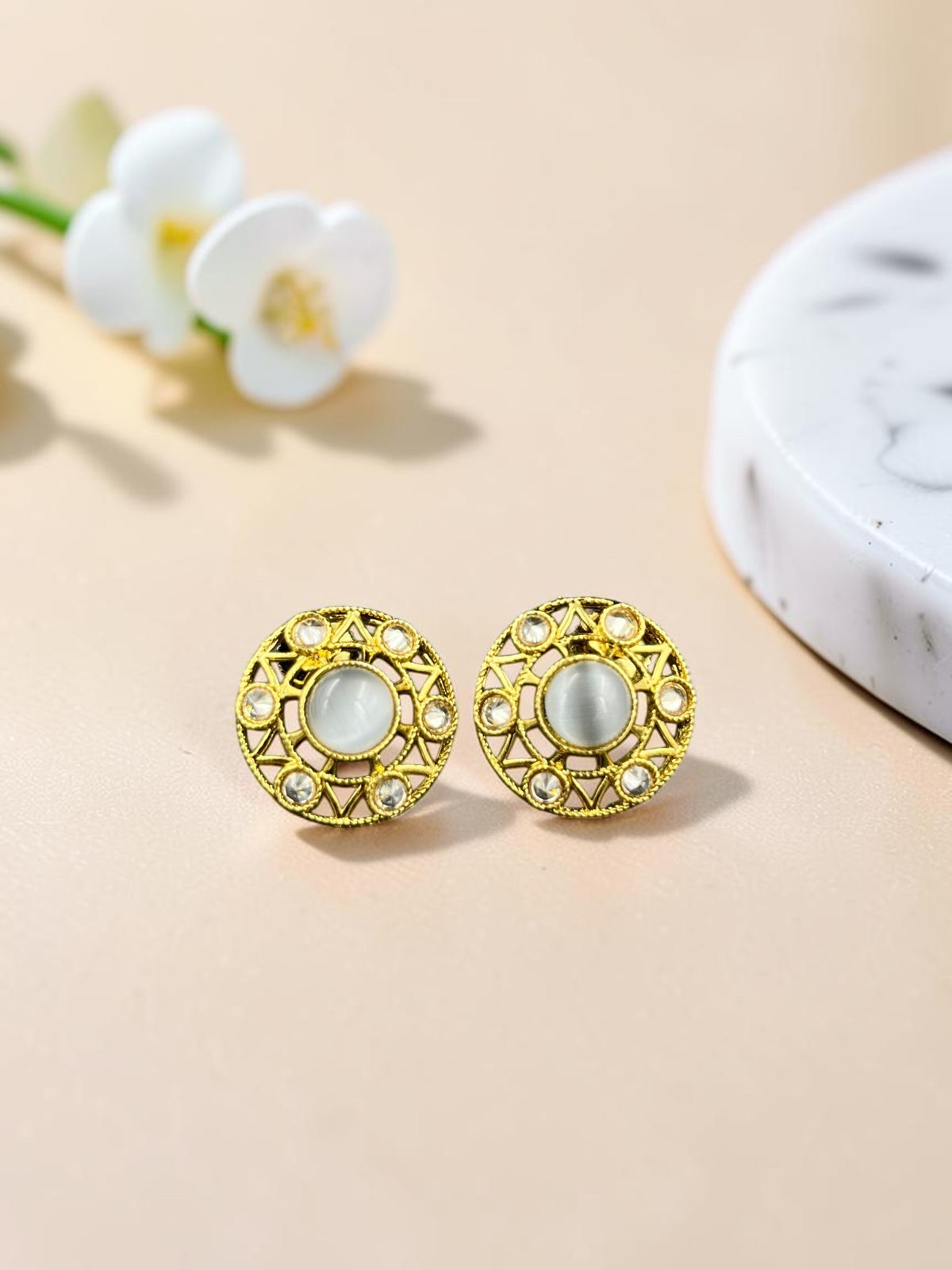 SHE BEAUTY antique gold-toned stud earrings with a central white stone and intricate circular filigree detailing
