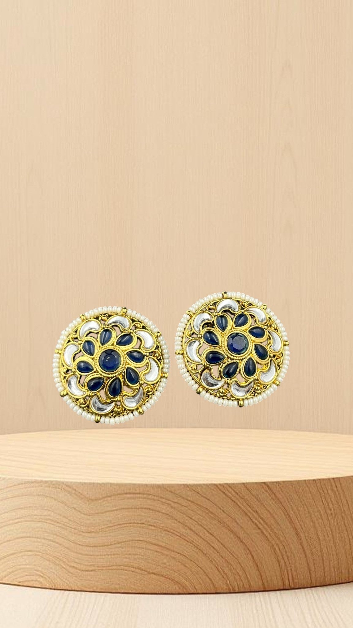 SHE BEAUTY antique kundan tops featuring blue stones, white accents, and pearl detailing in a circular gold setting.