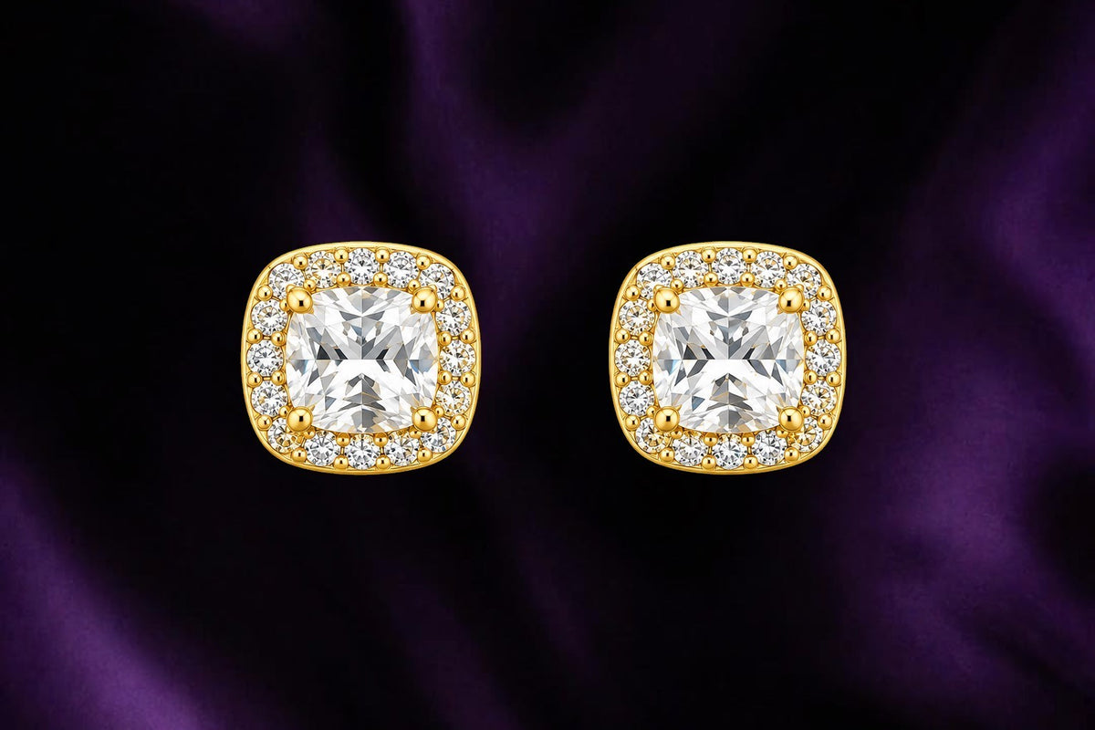 SHE BEAUTY Aurelia cushion-cut stud earrings featuring a central clear stone surrounded by a halo of small crystals.