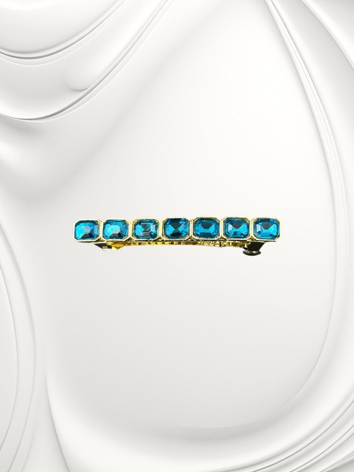 SHE BEAUTY barrette featuring seven rectangular blue gemstones set in a gold-tone metal frame for festive hair styling.