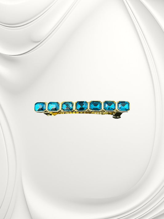SHE BEAUTY barrette featuring seven rectangular blue gemstones set in a gold-tone metal frame for festive hair styling.