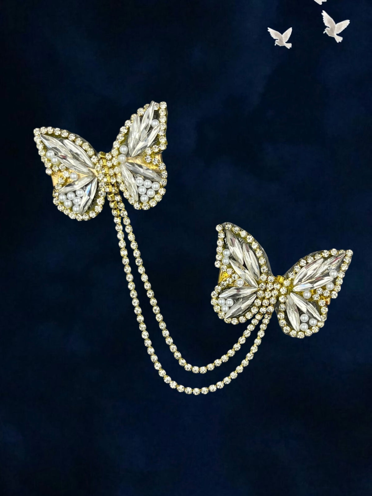 SHE BEAUTY butterfly hair pins featuring crystal rhinestones, pearls, and a delicate connecting chain on dark blue