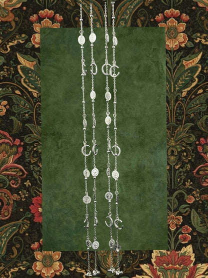 SHE BEAUTY 4-piece silver-toned chain set featuring crescent moon, coin, and bell charms for festive party wear.
