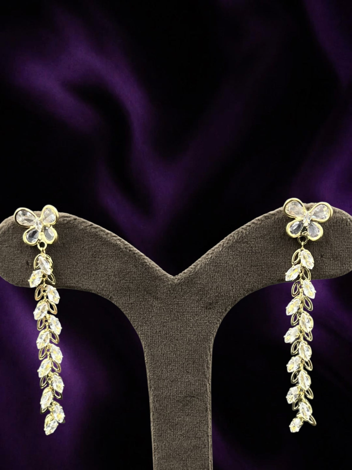 SHE BEAUTY CRYSTAL TRAILS earrings featuring gold-tone butterfly studs with cascading marquise-cut crystal dangles.