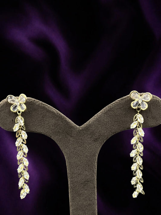 SHE BEAUTY CRYSTAL TRAILS earrings featuring gold-tone butterfly studs with cascading marquise-cut crystal dangles.