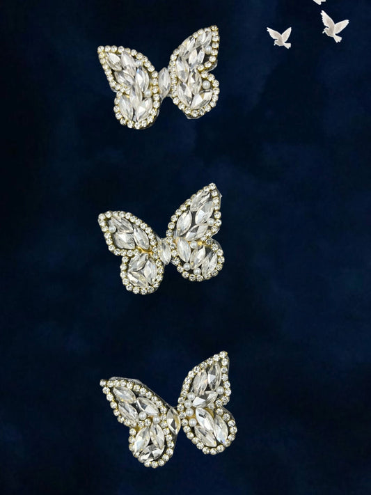 SHE BEAUTY crystal butterfly hair pins with clear marquise stones and pearl accents on a dark blue velvet background