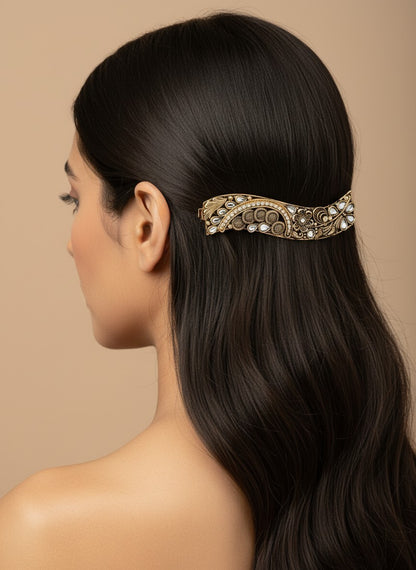 SHE BEAUTY curved vintage metallic barrette with intricate floral engravings and white stone accents in dark hair