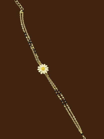 SHE BEAUTY anti-tarnish mangalsutra bracelet featuring a delicate white daisy flower charm and black beads.