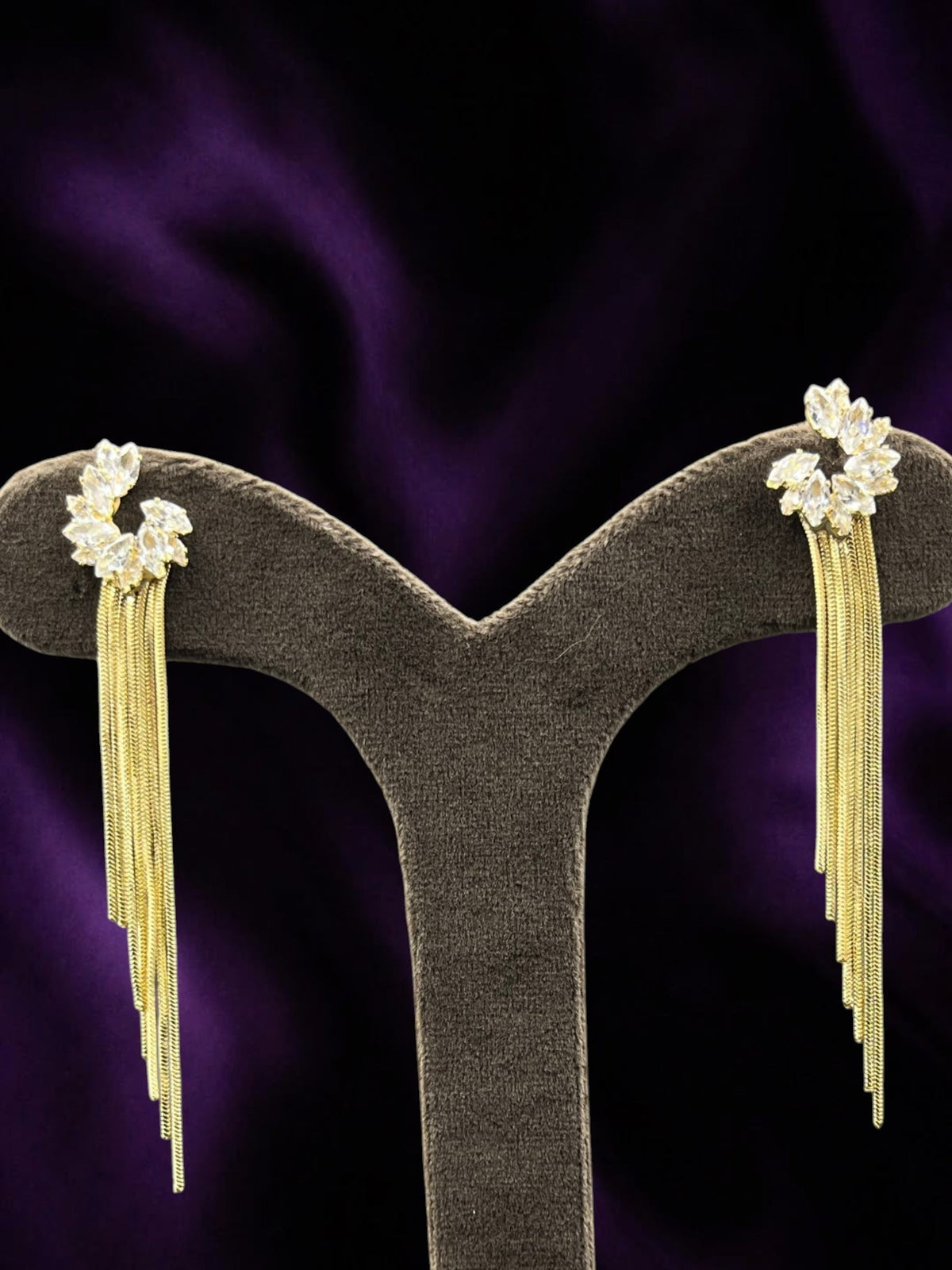 SHE BEAUTY FLORA FRINGE gold-toned tassel earrings with marquise-cut white stones for festive party wear.
