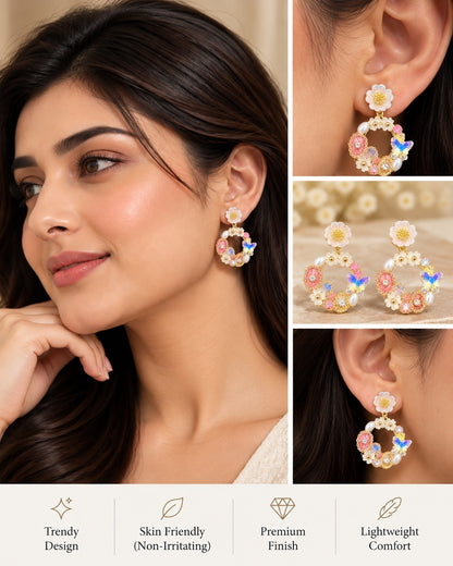 SHE BEAUTY FLORAL ARC earrings featuring floral and butterfly motifs with pearls, worn by a woman for festive wear.