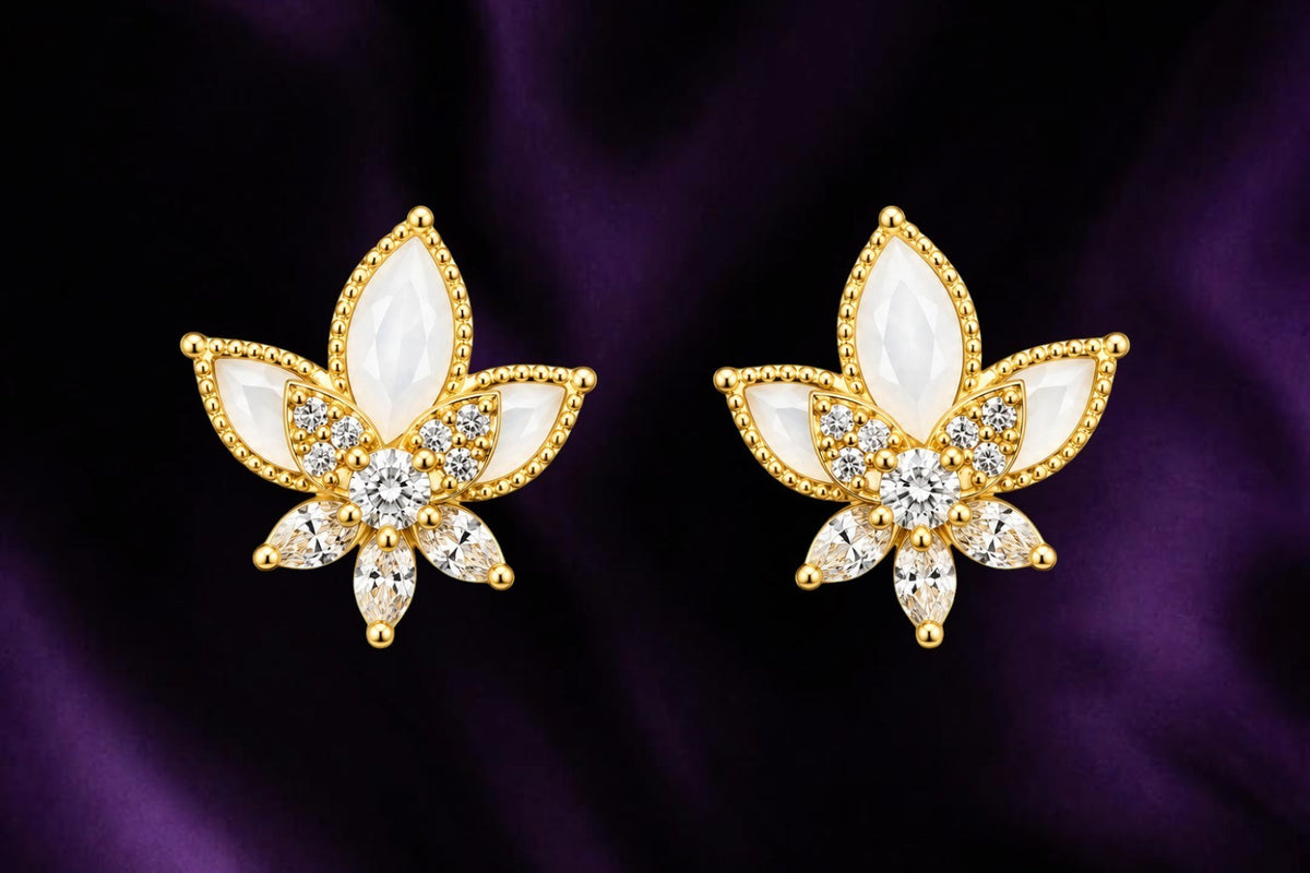 SHE BEAUTY Floral Charm gold-tone stud earrings featuring white petals and sparkling clear crystals on purple silk