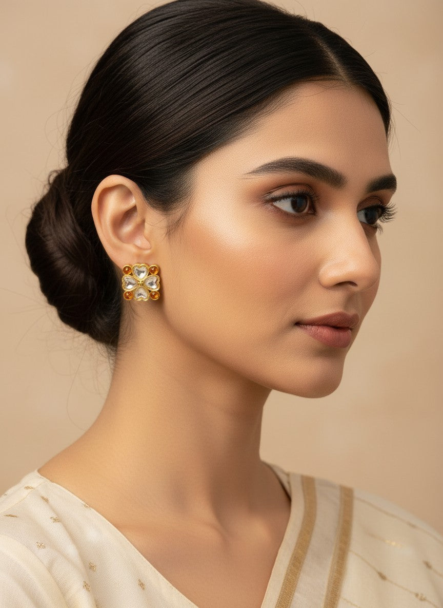 SHE BEAUTY light kundan tops featuring a floral gold design with clear and amber stones worn by a woman