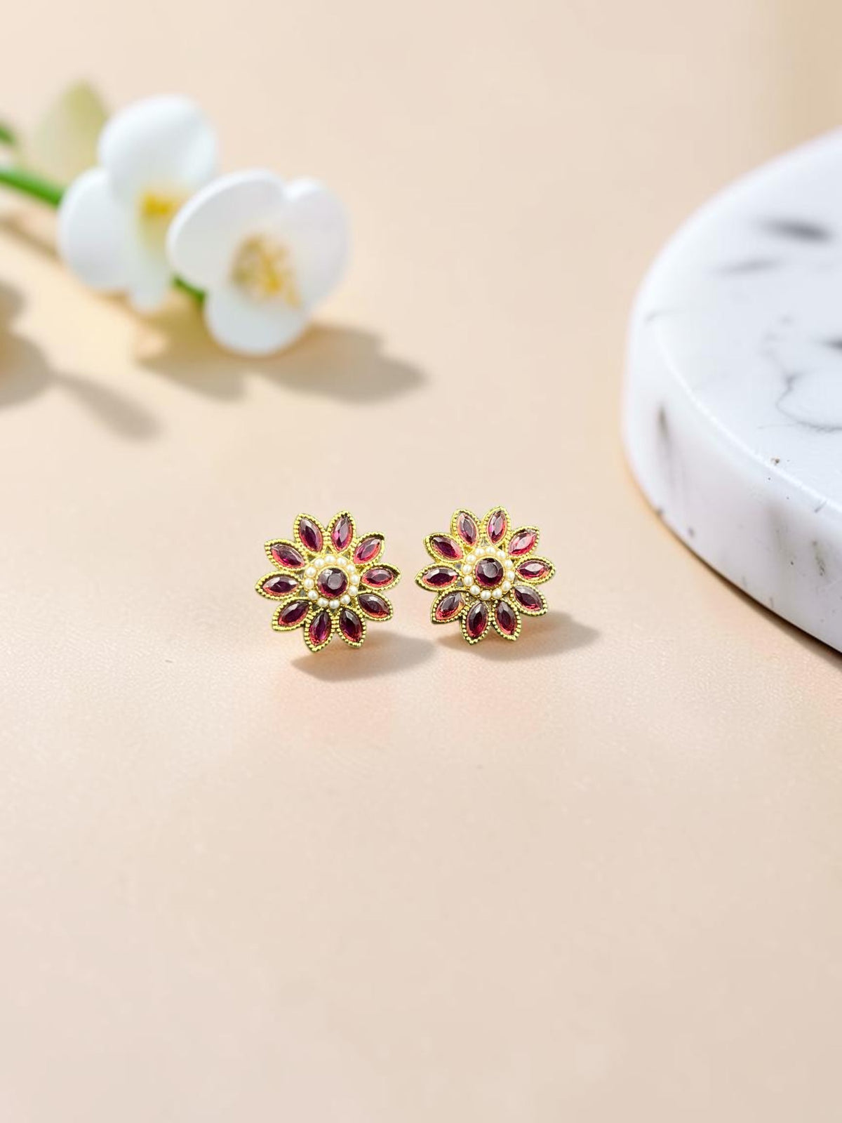 SHE BEAUTY floral stud earrings featuring maroon marquise stones and pearl accents in a gold-toned setting