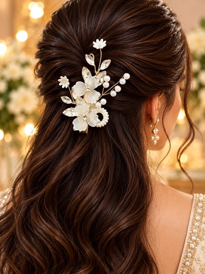 SHE BEAUTY twin floral hair pin with white petals, crystals, and pearls styled in wavy brown hair for festive wear.