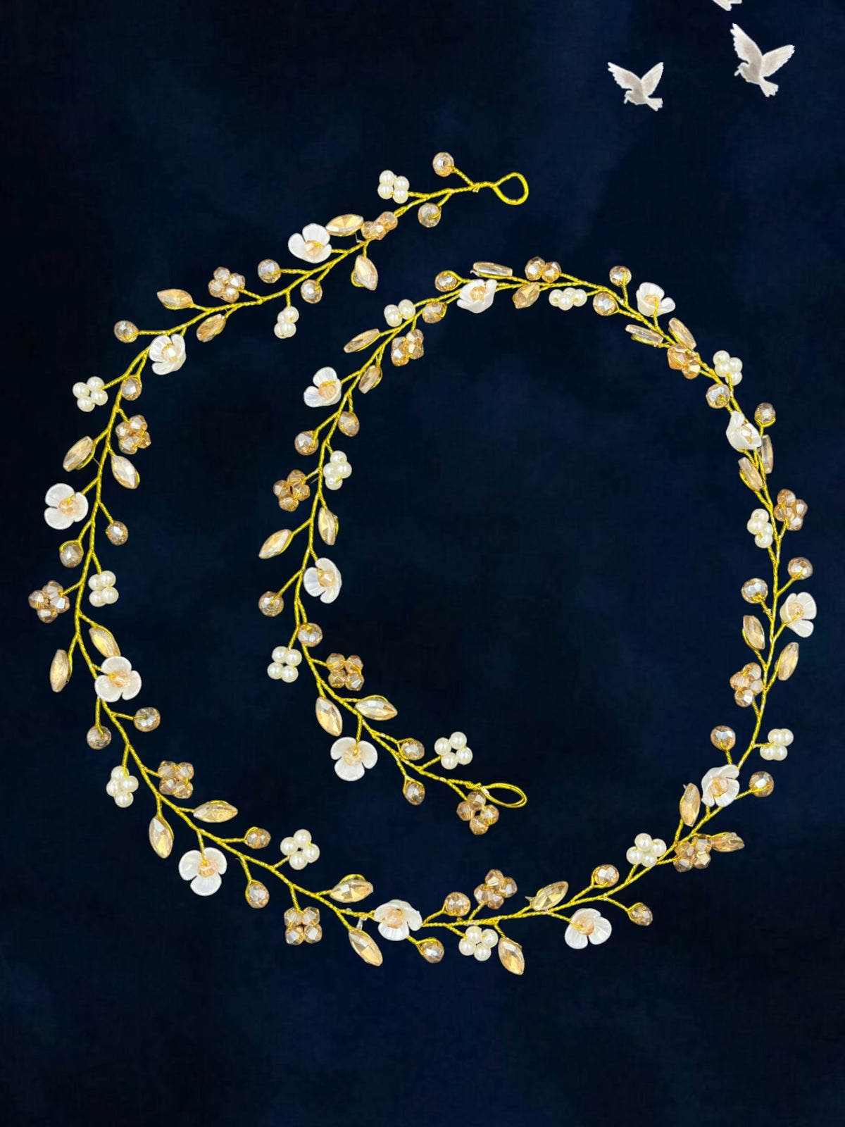 SHE BEAUTY floral hair vine featuring white petals, clear crystals, and pearls on a flexible gold wire for bridal wear.