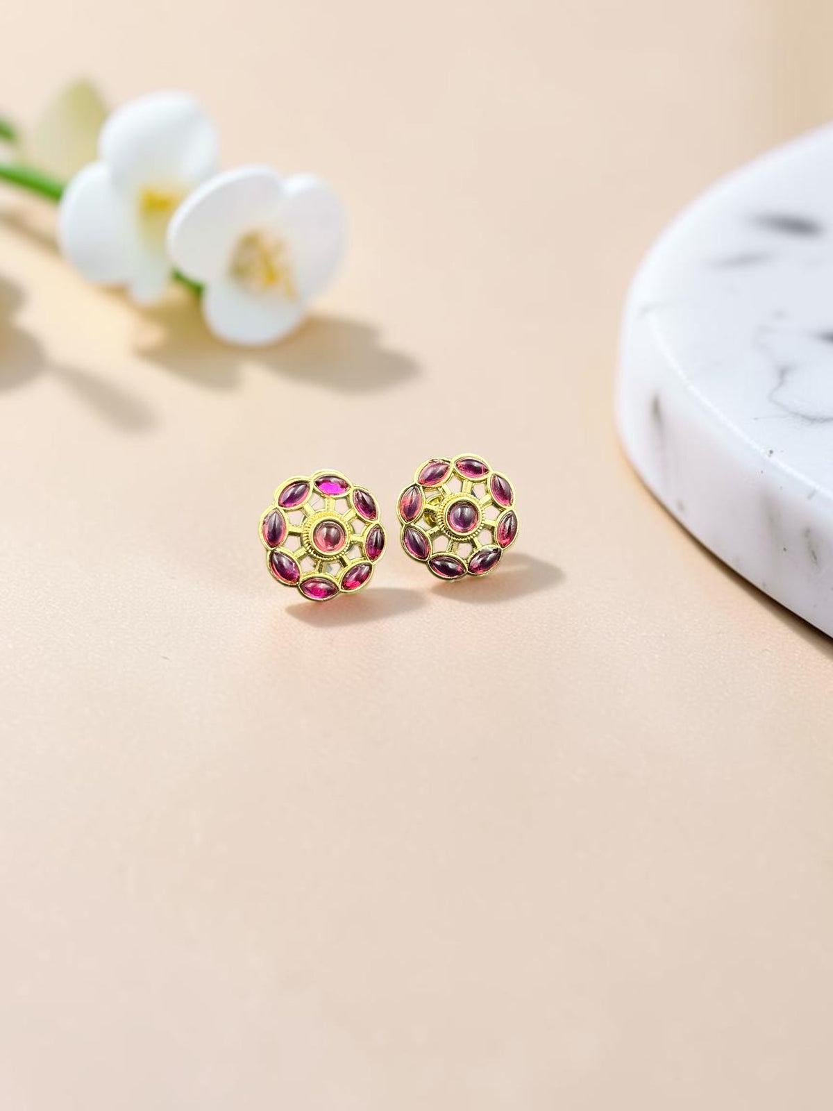 SHE BEAUTY gold-toned floral stud earrings with vibrant pink marquise and round stones for ethnic and festive wear.
