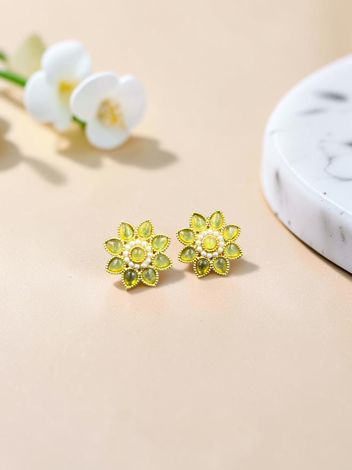 SHE BEAUTY floral stud earrings with yellow teardrop stones and pearl accents in a gold-toned setting