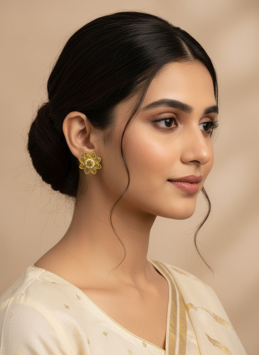SHE BEAUTY floral stud earrings in lime green with gold accents worn by a woman in a cream ethnic outfit