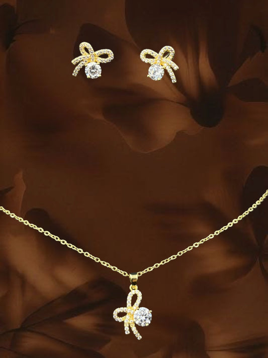 SHE BEAUTY flower knot pendant and earring set in gold tone with sparkling clear cubic zirconia stones