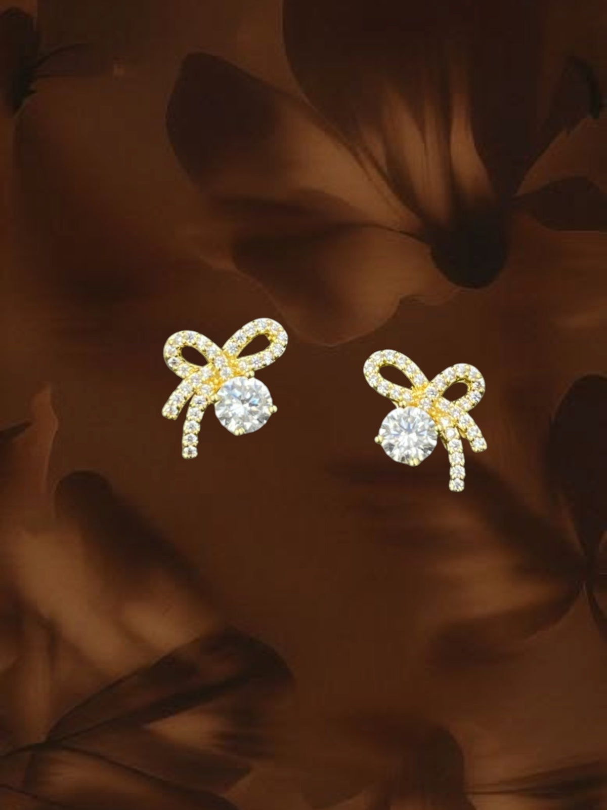 SHE BEAUTY flower knot stud earrings in gold with sparkling white cubic zirconia stones for festive party wear