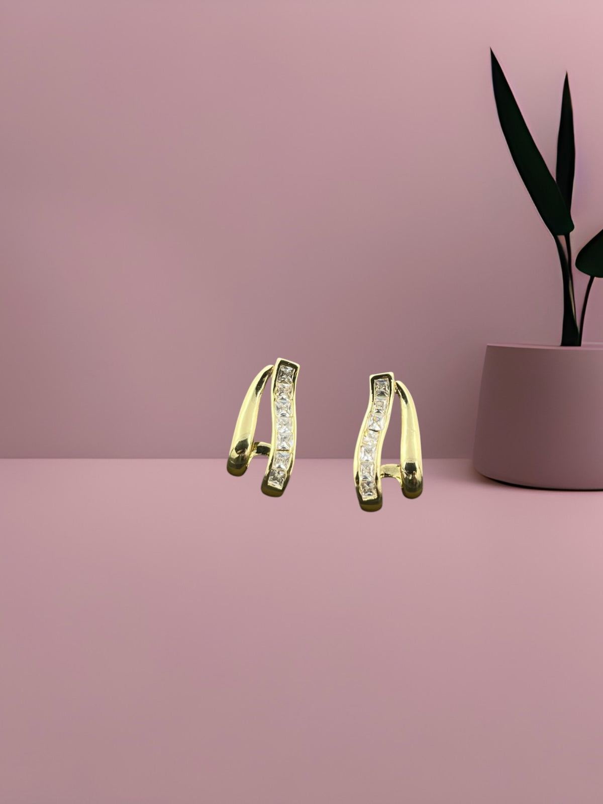 SHE BEAUTY GILDED LOOP gold-toned hoop earrings featuring a central row of sparkling clear cubic zirconia stones.