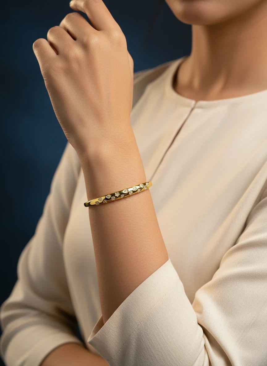SHE BEAUTY anti-tarnish gold-tone bracelet featuring sparkling AD stones on a woman's wrist for festive wear.