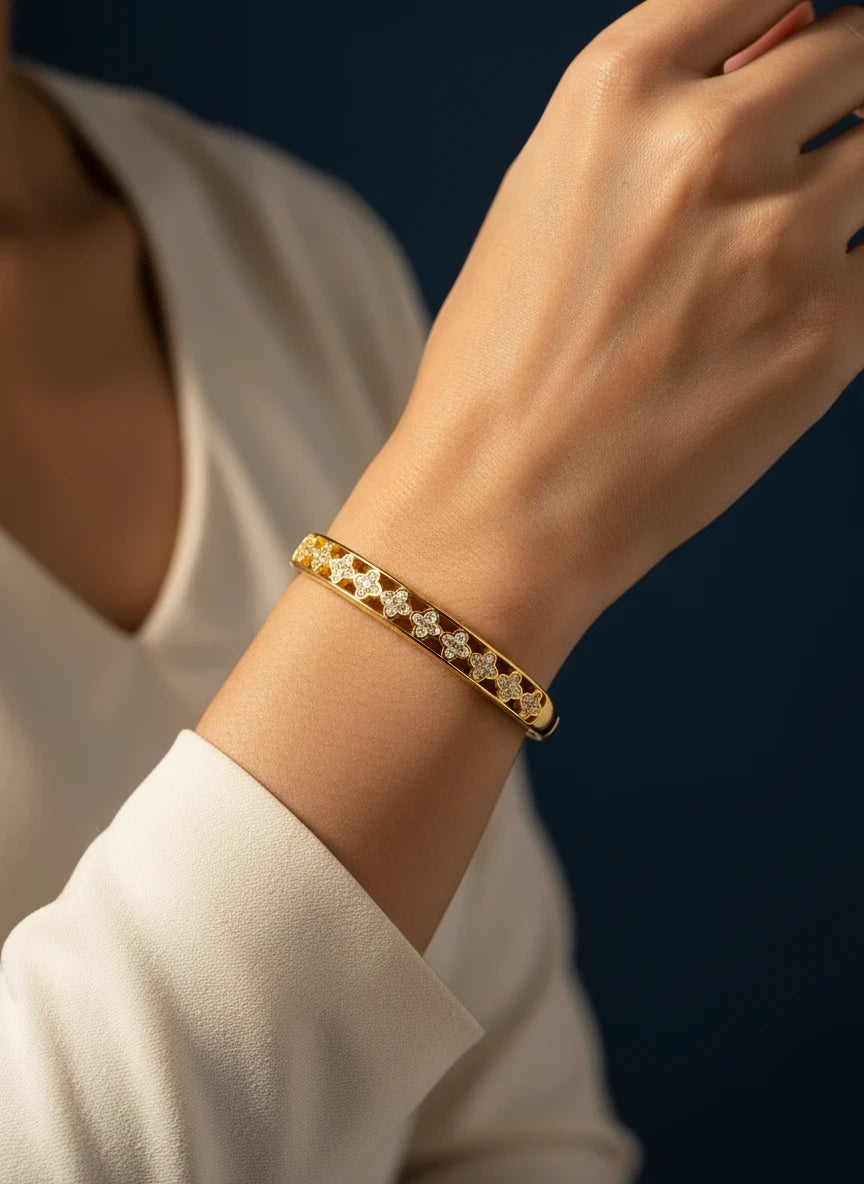 SHE BEAUTY gold-toned anti-tarnish AD bracelet featuring a delicate floral pattern with sparkling stone accents