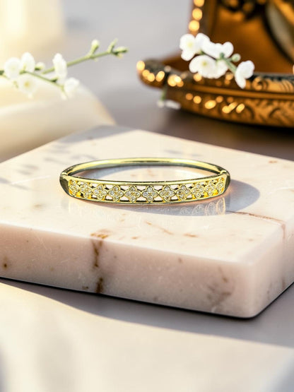 SHE BEAUTY anti-tarnish gold-tone AD bracelet featuring a delicate clover-inspired pattern with sparkling stones.