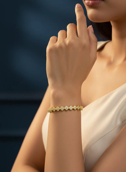 SHE BEAUTY anti-tarnish gold-tone AD bracelet with intricate floral-shaped stone settings worn on a woman's wrist