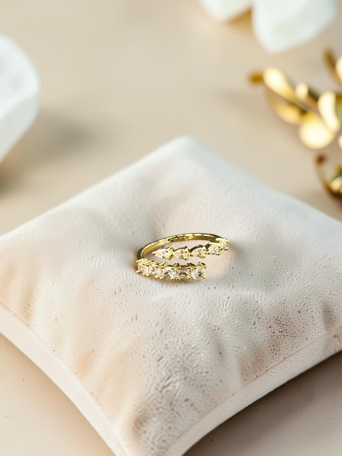 SHE BEAUTY gold-toned anti-tarnish ring featuring sparkling AD stones on a soft velvet display cushion