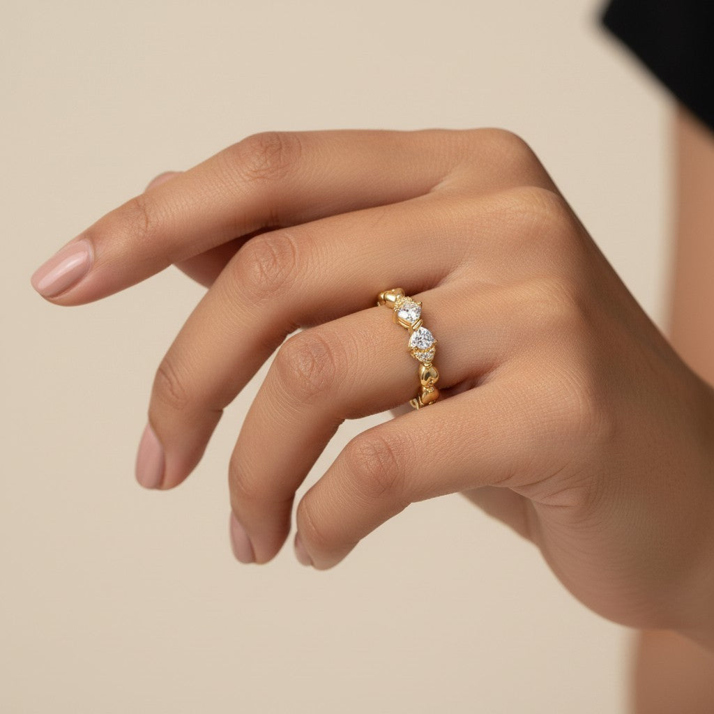 SHE BEAUTY gold-toned anti-tarnish ring featuring sparkling AD stones on a delicate heart-link band on a hand