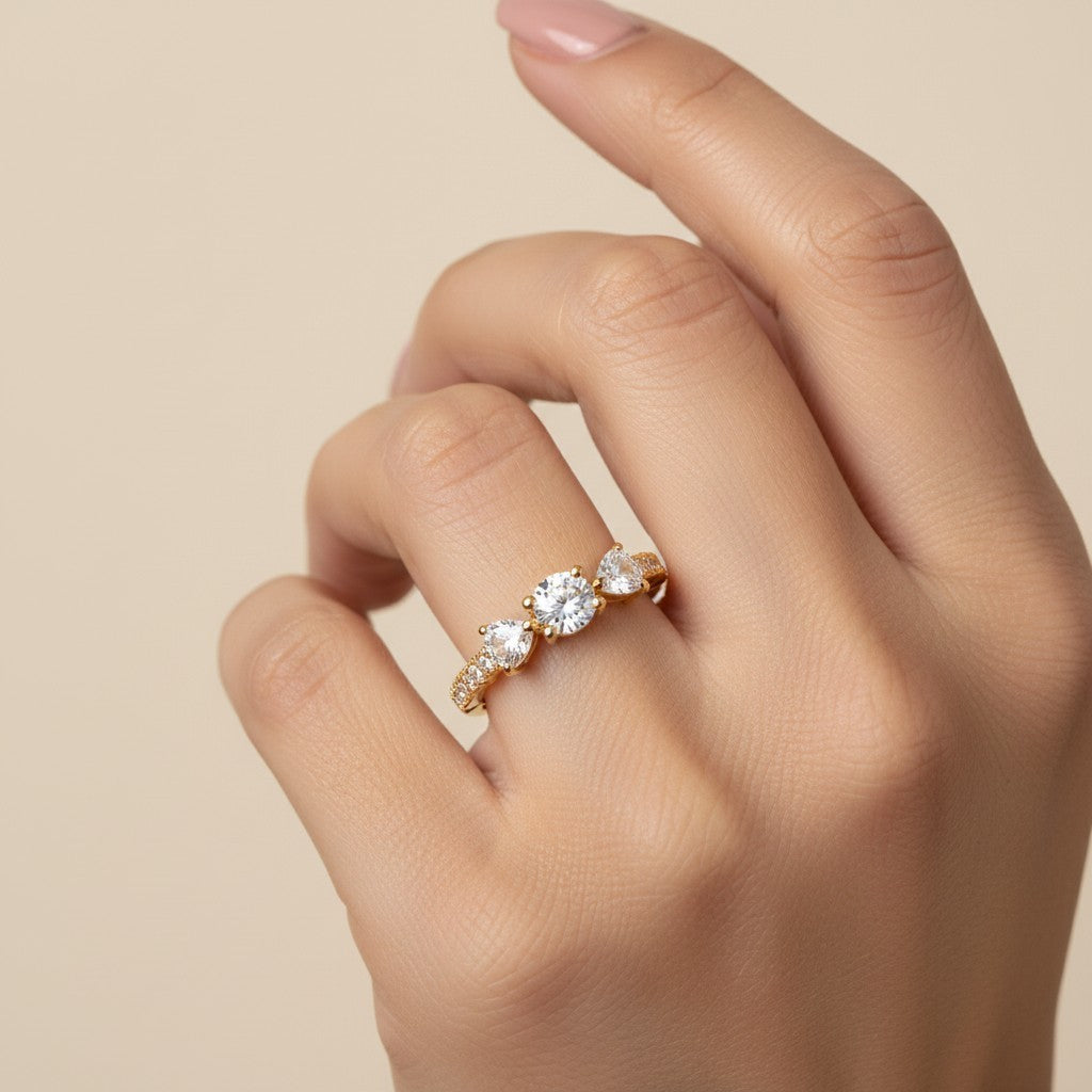 SHE BEAUTY anti-tarnish gold-tone ring featuring three sparkling round-cut AD stones on a delicate band