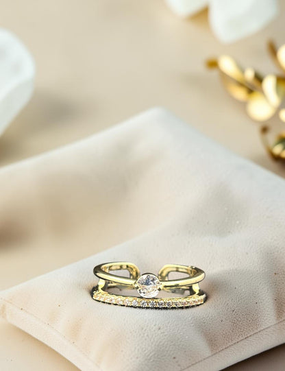 SHE BEAUTY gold-toned anti-tarnish ring featuring a central round stone and a delicate pave-set band
