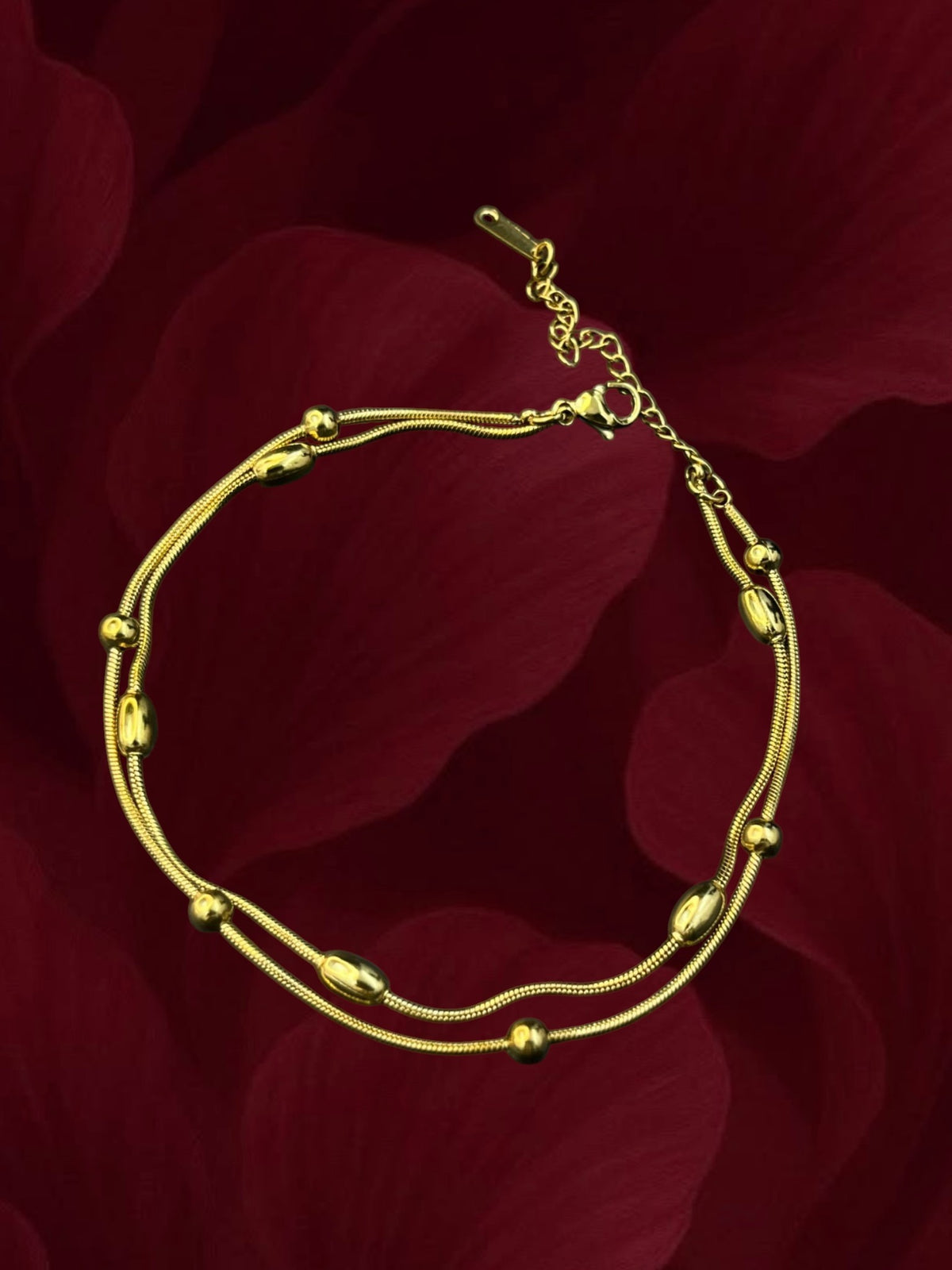 SHE BEAUTY KIYU ZIYU gold-toned double-strand anklet with polished beads, perfect for festive or everyday wear.