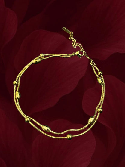 SHE BEAUTY KIYU ZIYU gold-toned double-strand anklet with polished beads, perfect for festive or everyday wear.