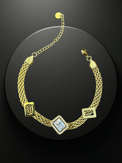 SHE BEAUTY KIYU ZIYU gold-tone chain bracelet with a central rectangular crystal and geometric accents