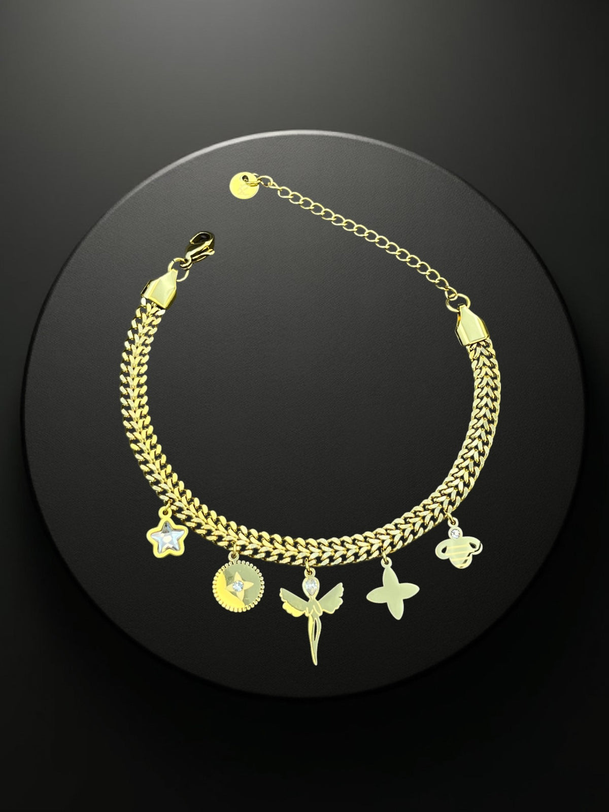 SHE BEAUTY KIYU ZIYU gold-tone chain bracelet featuring dangling charms including a star, fairy, and flower.